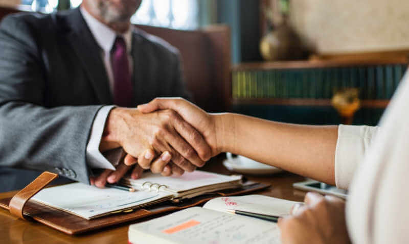 Attorney shaking a clients hand