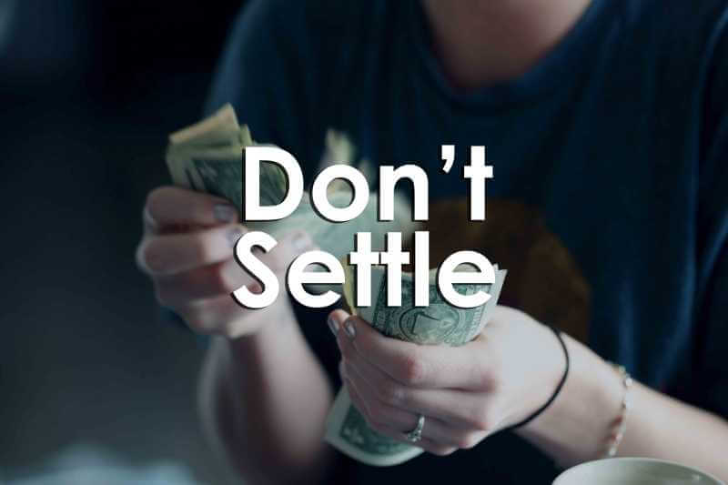 This is a photo of a female counting money. The words "Don't Settle" are written in white font across the photo.